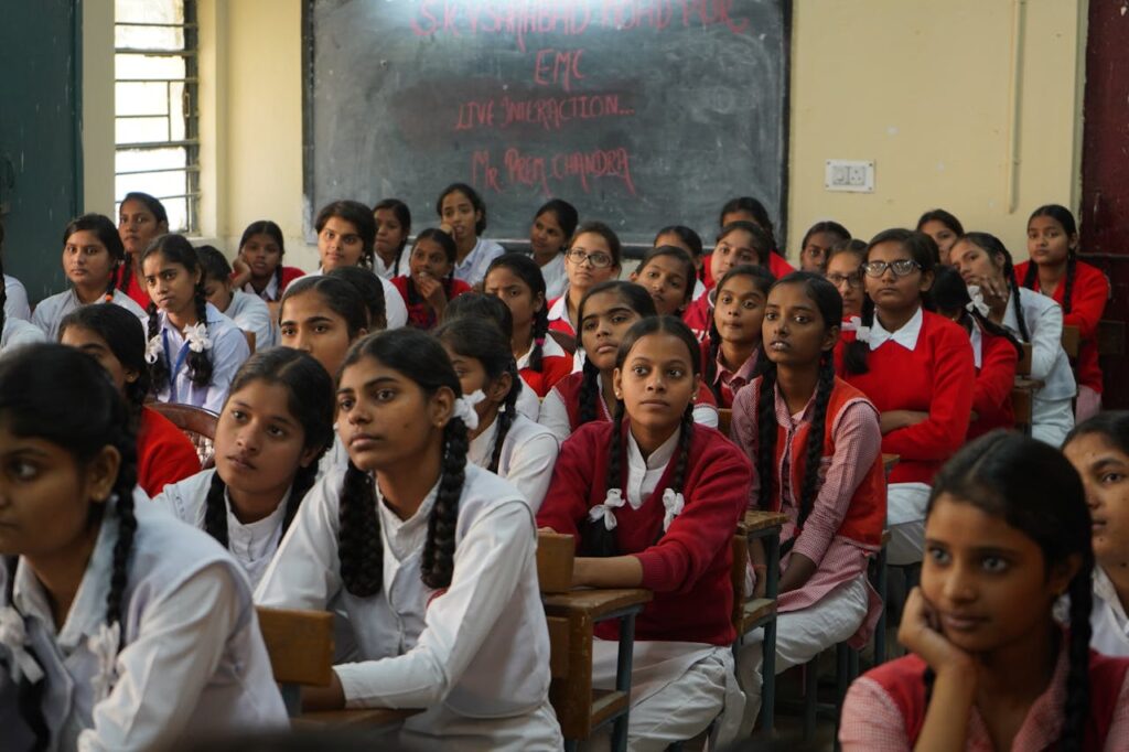 pexels-photo-3231359 Group of Indian schoolgirls in uniform attentively listening in a classroom setting.